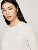 Sweater de lana color blanco, con cuello redondo, puños y bajo vueltos. Logo de Tommy Hilfiger bordado en el pecho.