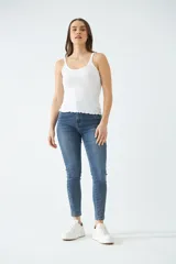Jean clásico de dama, de tiro alto y fit skinny, con cremallera y cierre, disponible en color blanco.