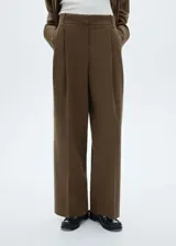 Pantalón de vestir marrón con finas rayas verticales, corte wideleg, tiro alto, bolsillos laterales y cierre frontal oculto.