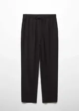 Pantalón color verde oliva, de tejido fluido, corte recto, tiro alto, cintura elástica con cordón de ajuste y bolsillos laterales.