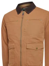 Chaqueta color marrón claro con cuello marrón de pana, cierre frontal con cremallera y broches, dos bolsillos superiores con broches y dos bolsillos inferiores con solapa y broches.