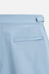 Bañador corto celeste de tejido técnico con cintura elástica ajustable con cordón interior y trabillas laterales. Cuenta con bolsillos frontales, bolsillo trasero con cierre de cremallera y forro interior.