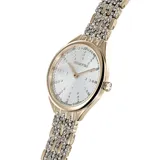 Reloj Swarovski Attract con caja redonda en tono oro champán y esfera guilloché plateada. El bisel y la correa metálica están engastados con cristales transparentes.