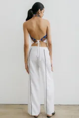 Pantalón recto color crema de lino con costuras laterales en negro.