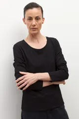 Remera de manga larga color blanco con escote a la base y corte recto.