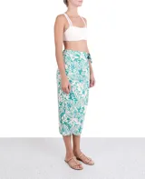 Falda midi de tiro alto con estampado floral en tonos turquesa y blanco, con lazo lateral.