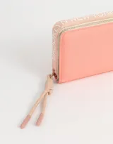 Billetera de tela deportiva colorblock en tonos rosa y beige, con cierre circundante y tirador de cordón y goma.