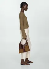 Pantalón negro de lino con diseño crop y jogger, tiro medio, cintura elástica con lazo, dos bolsillos laterales y dos bolsillos de ribete en la parte posterior.