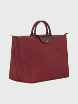 Bolso de viaje grande Longchamp Le Pliage Green XL, color verde jade, con doble asa corta y cierre superior con cremallera y botón a presión.