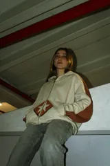 Hoodie con cierre color crema y mangas marrones, corte boxy, estampado con serigrafía.