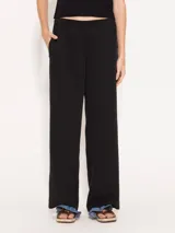 Pantalón negro de tencel con lino, de corte recto y caída liviana. Tiene elástico en la cintura, falsa cartera, bolsillos escondidos en el delantero y bolsillo ojal en la espalda.