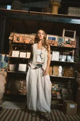 Chaleco negro de vestir, sin mangas, con escote en V y cierre frontal de botones.