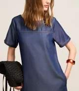 Vestido corto azul denim de liocel, con cuello redondo, mangas cortas y corte recto.