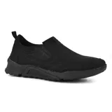 Zapato de vestir negro, tipo mocasín, sin cordones, con elásticos laterales y suela gruesa.