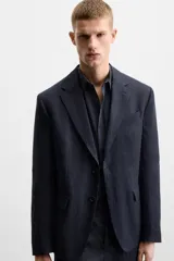 Blazer azul marino de lino, corte regular fit, con solapas de muesca, cierre de dos botones, bolsillo de vivo en el pecho, bolsillos de solapa en la cadera, aberturas en la espalda y puños con botones.