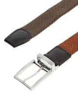 Cinturón elástico trenzado color marrón con terminaciones de cuero marrón oscuro y hebilla metálica plateada.