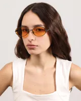 Lentes de sol con marco metálico negro y cristales color naranja.