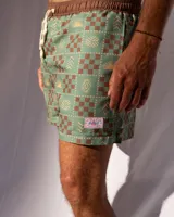Short de baño verde con estampado de figuras geométricas en marrón y beige, cintura elastizada con cordón ajustable.