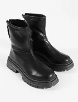Botas cortas color crema, de cuero vegano, con suela track y cierre trasero con cremallera.