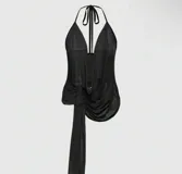 Top negro de malla transparente con escote halter y lazo en la cintura.