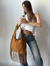 Cartera marrón de simil gamuza con flecos.