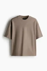 Remera color marrón topo de punto de algodón pesado, corte oversized, cuello redondo ribeteado, hombros caídos y bajo recto.