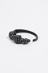 Pulsera rígida negra con forma de pantera con incrustaciones de strass blancos y rosados.