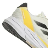 Championes Adidas Duramo Speed color crema con detalles en negro, naranja y amarillo. Zapatillas de running con capellada de malla y amortiguación Lightstrike.