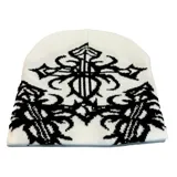 Gorro de poliéster color blanco con estampado de cruces y arabescos en negro.