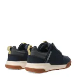 Zapatos bajos Caterpillar modelo Hex Ready Lo, color azul marino, con capellada de nobuk o cuero sintético. Suela gruesa bicolor, con entresuela color crema y suela exterior de goma marrón con diseño de hexágonos. Cordones grises con puntos blancos y detalles en amarillo claro en la lengüeta y tirador trasero.