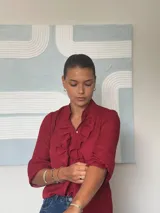 Camisa roja de manga larga con volados frontales y cuello mao.