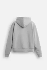 Sudadera negra relaxed fit de algodón compacto con interior en rizo, cuello con capucha ajustable, manga larga, bolsillos frontales tipo canguro, acabados en rib y cierre frontal con cremallera.