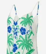 Vestido corto con breteles finos y escote en V, confeccionado en viscosa y lino. Presenta una estampa tropical con palmeras verdes, flores azules y dos aves azules enfrentadas. El ruedo tiene una franja azul con un detalle verde.
