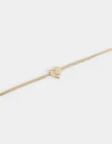 Pulsera dorada de cadena cola de ratón con dije de corazón adornado con strass y cierre de mosquetón.
