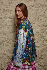 Camisa holgada estampada con motivos paisley en tonos marrón, beige y azul. Tiene cuello solapa, mangas largas y cierre frontal con botones.