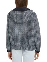 Cortavientos reversible con diseño de monograma, capucha con cordón y cierre de cremallera.