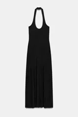 Vestido midi negro, confeccionado en tejido de punto, con escote halter y espalda descubierta. La falda es acampanada y con caída.