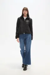 Campera marrón de poliéster con cuello y puños de corderito, cierre frontal y bolsillos laterales.