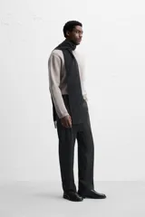 Sweater negro de punto con cuello redondo y mangas largas.