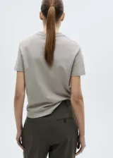 Camiseta blanca de algodón regenerativo, con cuello pico y manga corta.