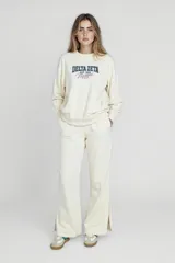 Pantalón de vestir blanco con corte palazzo y aberturas laterales en el ruedo.