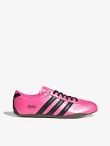 Zapatillas Adidas Originals Tokyo color rosa con las tres tiras laterales en negro, suela marrón y cordones negros.