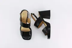 Sandalias de plataforma color borgoña, confeccionadas en charol. Tienen dos tiras anchas sobre el empeine, pulsera con hebilla al tobillo y taco cuadrado de 9 cm.