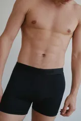 Pack de dos boxers negros con cintura elástica gris con la marca Carouon en blanco.