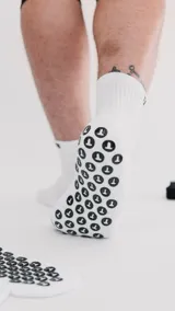 Soquetes blancos con detalles de tejido en diferentes texturas y logo de la marca en el tobillo.