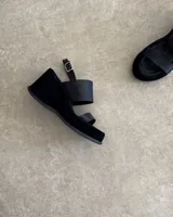 Sandalias de cuero vacuno color marrón, con plataforma y tiras cruzadas.