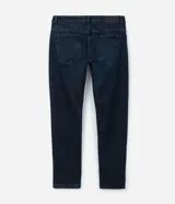 Pantalón slim fit confeccionado en tejido denim azul oscuro, con cintura con trabillas, cierre tradicional y bolsillos.