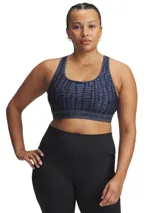 Top deportivo Under Armour con estampado floral en tonos rosa y amarillo sobre fondo negro. Cuenta con tirantes cruzados en la espalda y banda elástica con el logo de la marca en el contorno inferior.