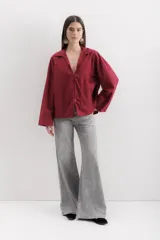 Camisa blanca de algodón con cuello clásico, mangas largas con puños abotonados y bolsillo de parche en el frente.