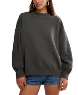 Suéter de algodón color gris oscuro, con cuello mock (cuello alto corto) y calce oversized. Presenta mangas largas con puños ajustados y ruedo acanalado.